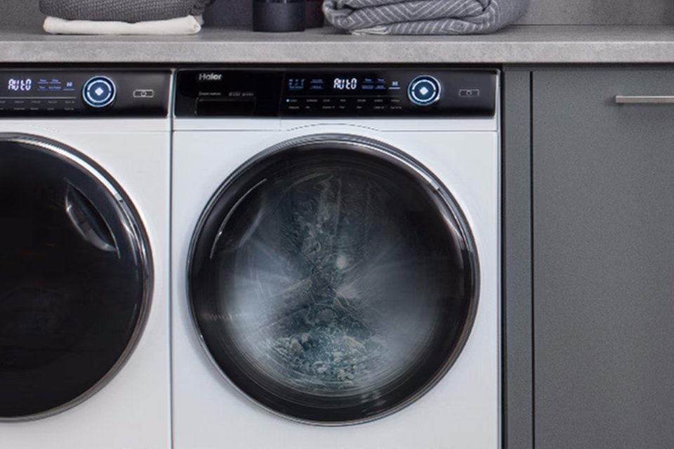 A silver Haier washing machine. 