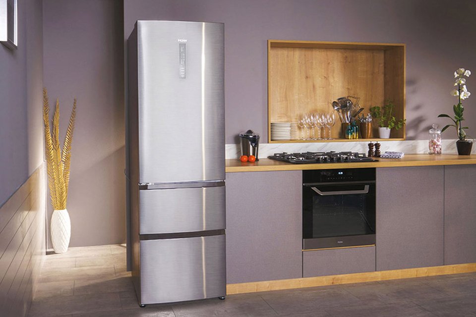 A silver Haier fridge freezer in a kitchen setup.
