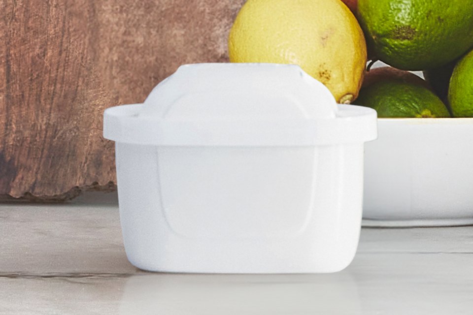 A BRITA water filter cartridge placed on a kitchen worktop.