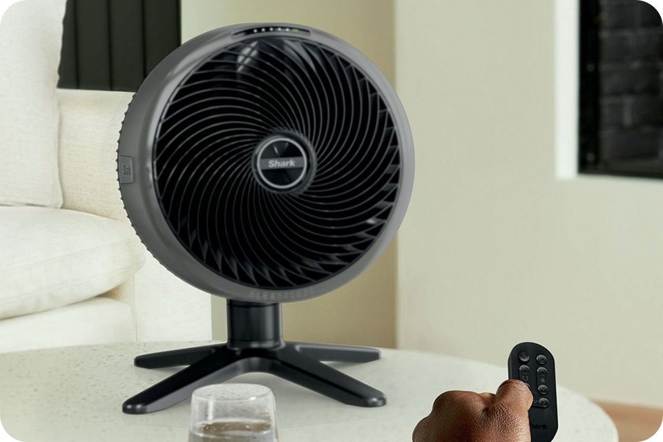 A black desk fan being remotely controlled