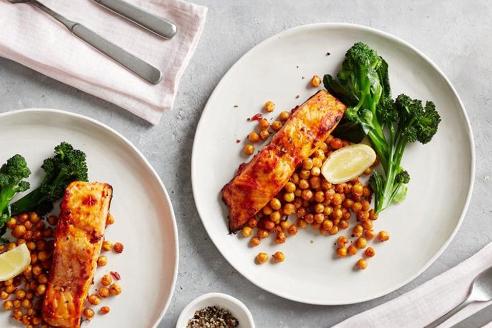 A plate of harissa salmon with crispy chickpeas and broccoli on the side. 