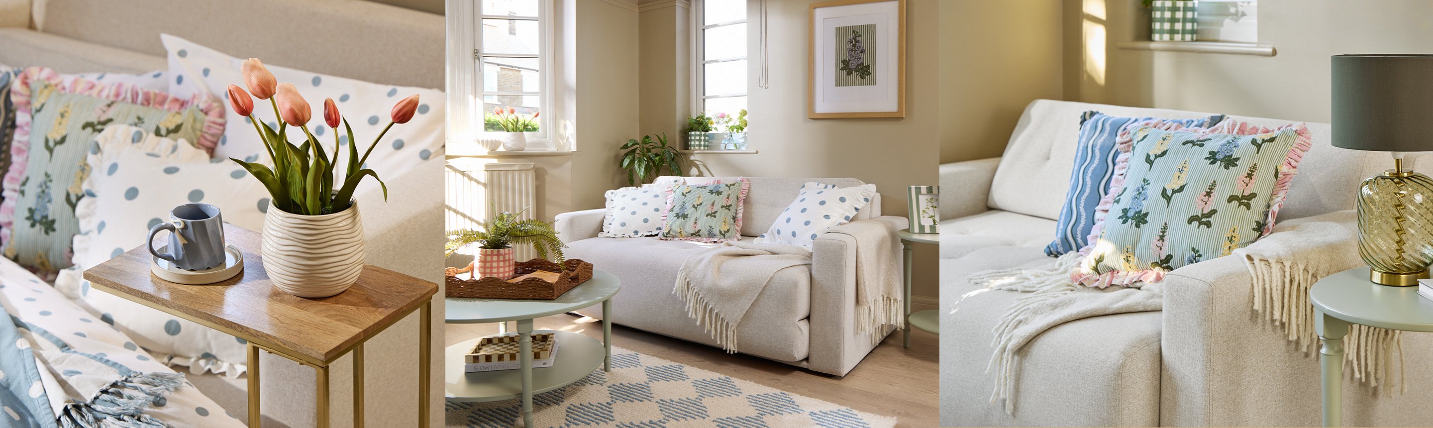 A vase of tulips on a side table, a round coffee table in front of a sofa, and throw pillows on a sofa near a side table.