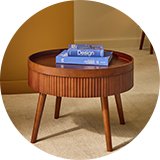 A Habitat Agnes coffee table in walnut with books placed on top of it in a living room.