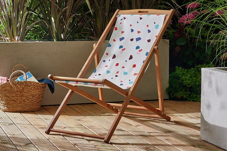 White spotted deck chair on decking.