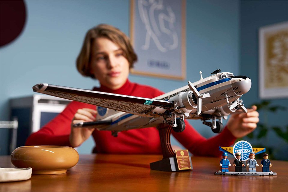 Woman admiring the LEGO® Icons Douglas DC-3 PAN AM Airliner set. 