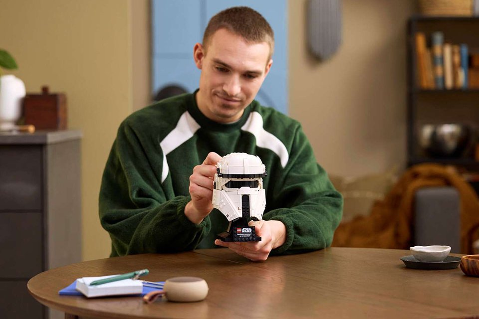 Man holding the LEGO® Star Wars Imperial Remnant AT-RT Driver Helmet set.