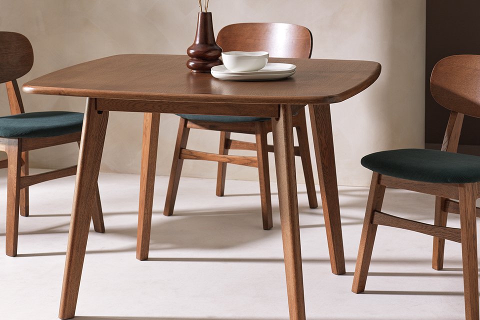 A Habitat x Scion Esala wood veneer four-seater dining table and three chairs in a dining room.