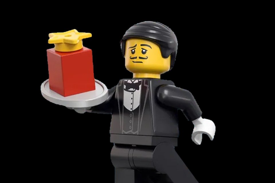  LEGO® minifigure of a waiter serving some LEGO® pieces on a tray. 