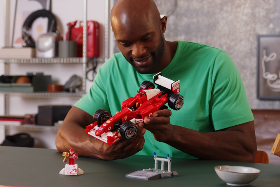Man holding the LEGO® Icons Ferrari F2004 set.