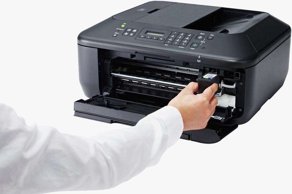 Man changing cartridge in black inkjet printer