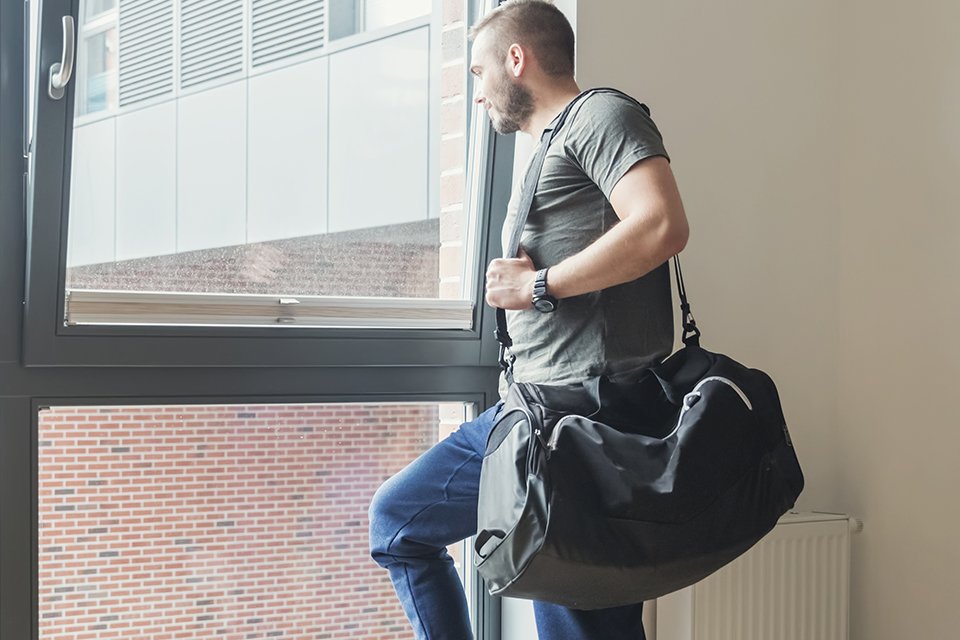 A man carrying a black holdall.