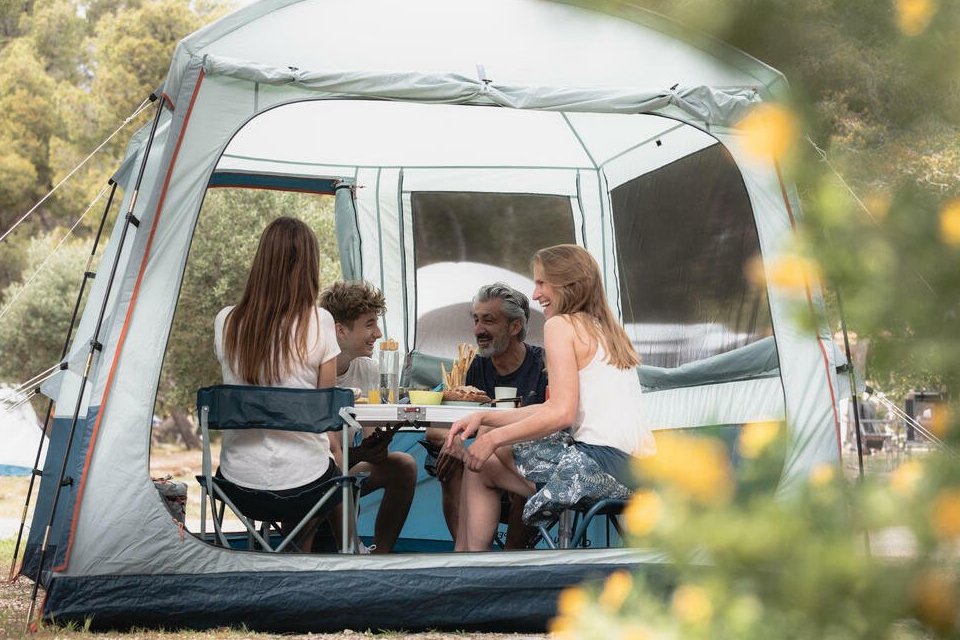 family camping in tent outside