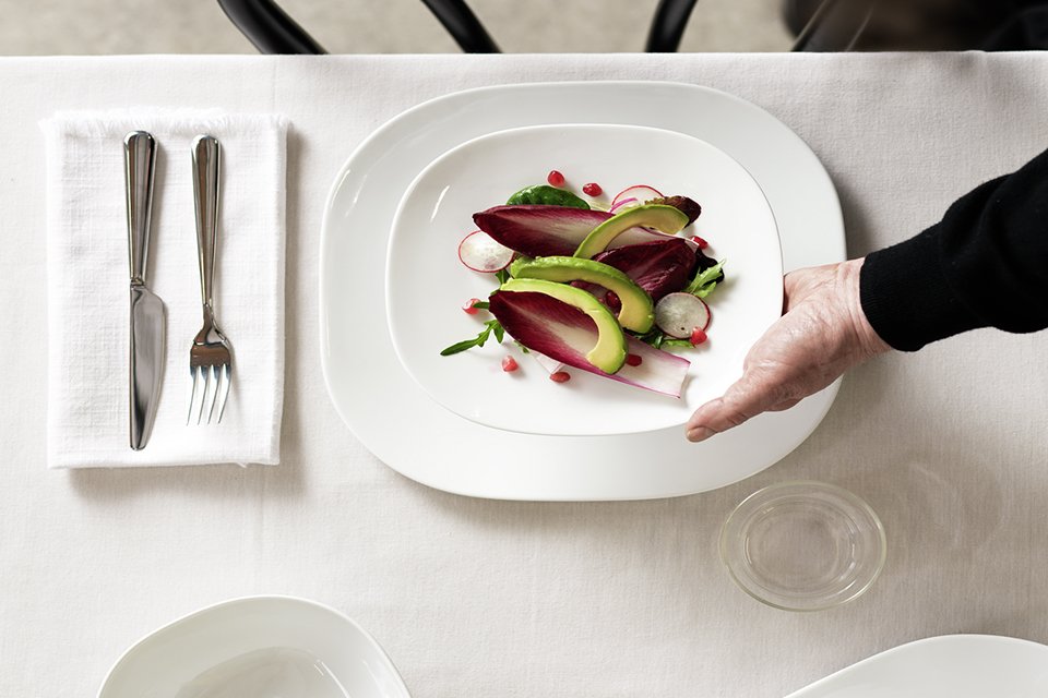 A table set with a white Sebastian Conran 12 piece porcelain dinner set.