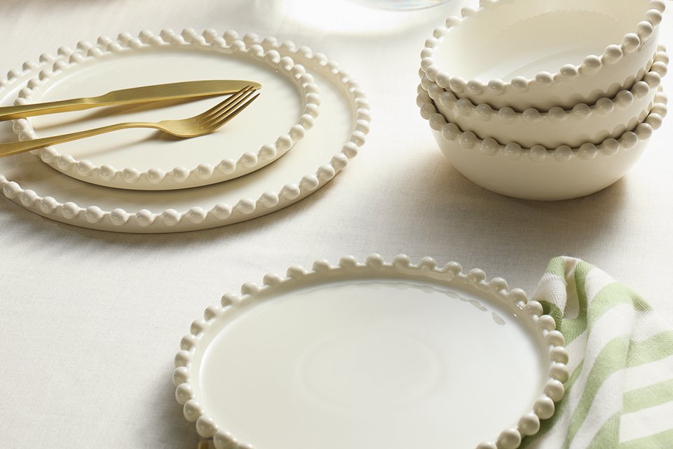 A table set with a Habitat Bobbin 12 piece stoneware dinner set in cream.