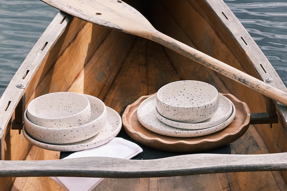 A Habitat dinneware set in white colour placed inside a boat.