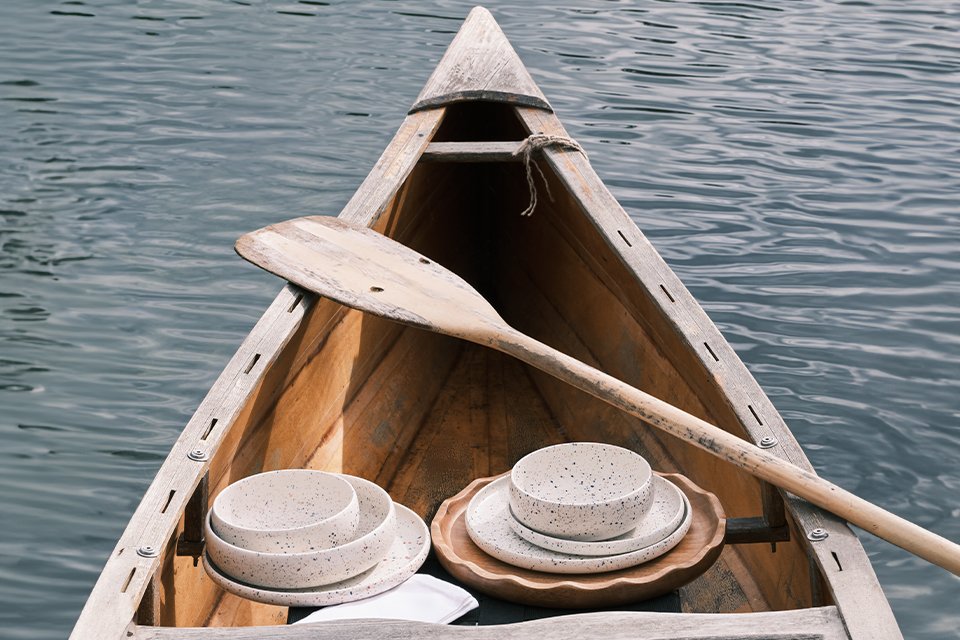 A Habitat dinneware set in white colour placed inside a boat.