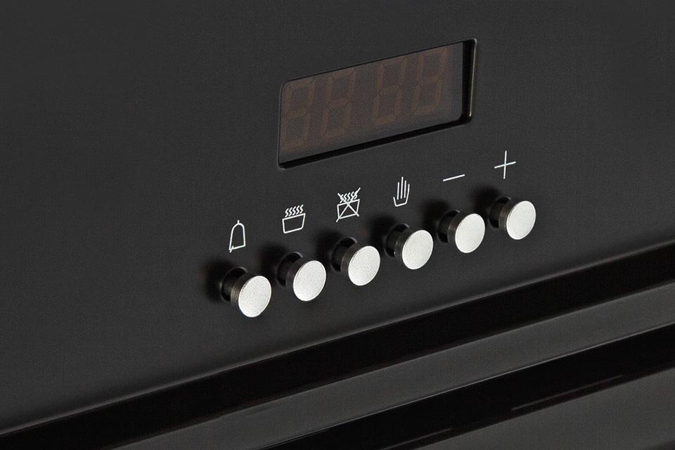 Close up of an oven timer and setting buttons.