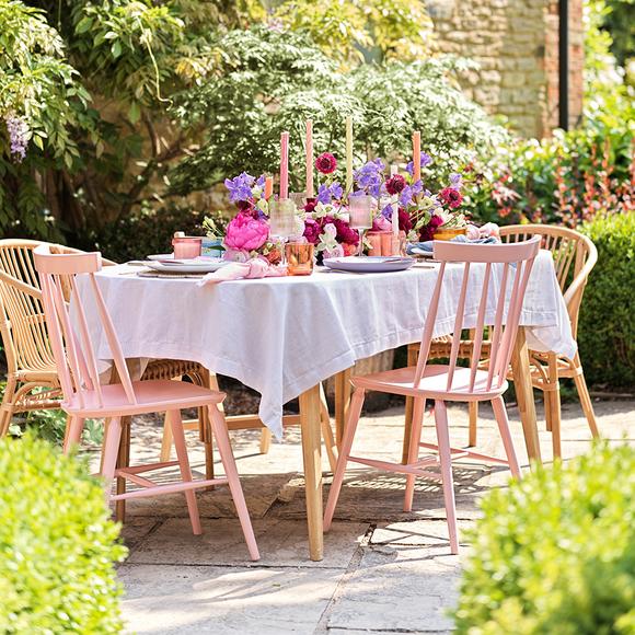 Vintage garden tea party in bright and bold colours with accessories and flowers.