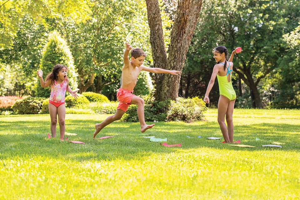 Children playing games in a sunny park.