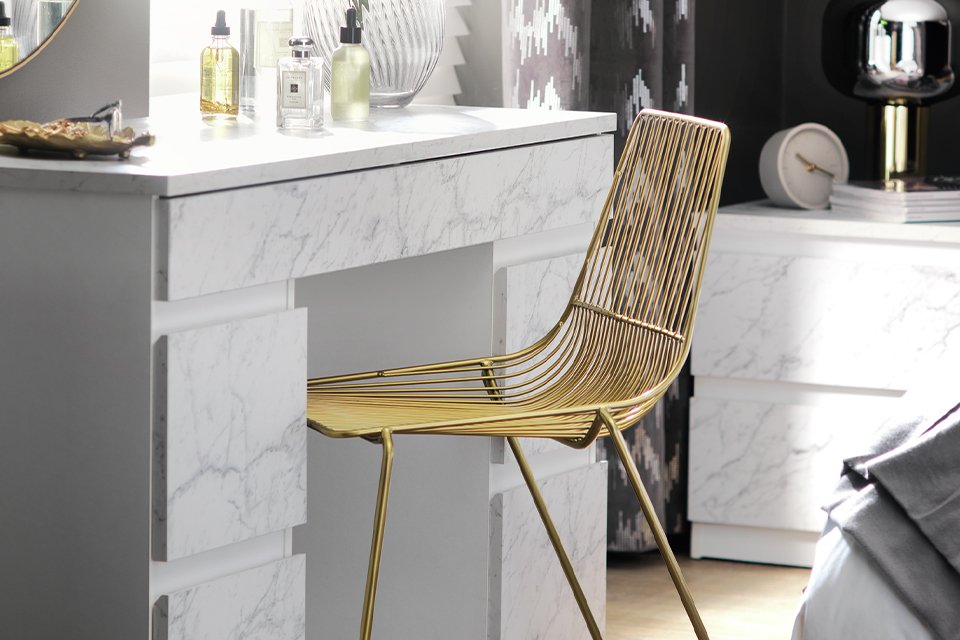 A 6 drawers marble dressing table in white colour.