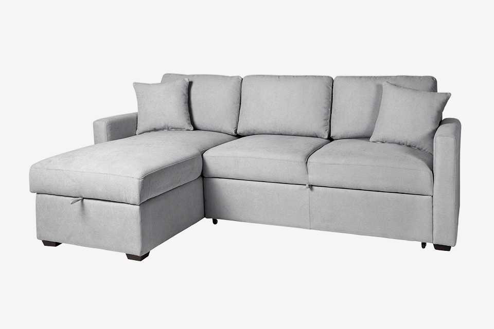  L shaped sofa bed in grey material.
