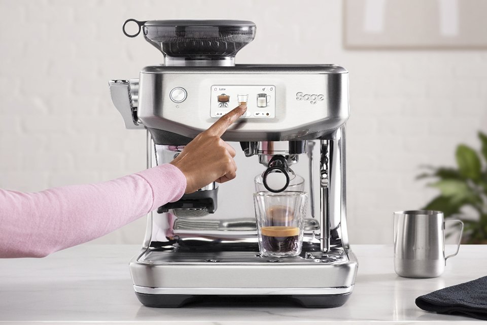 A Sage coffee machine pouring coffee in a cup.
