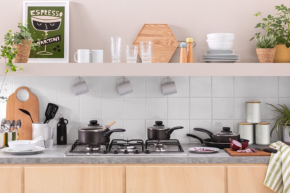 Kitchen set up with pots pans and a variety of accessories
