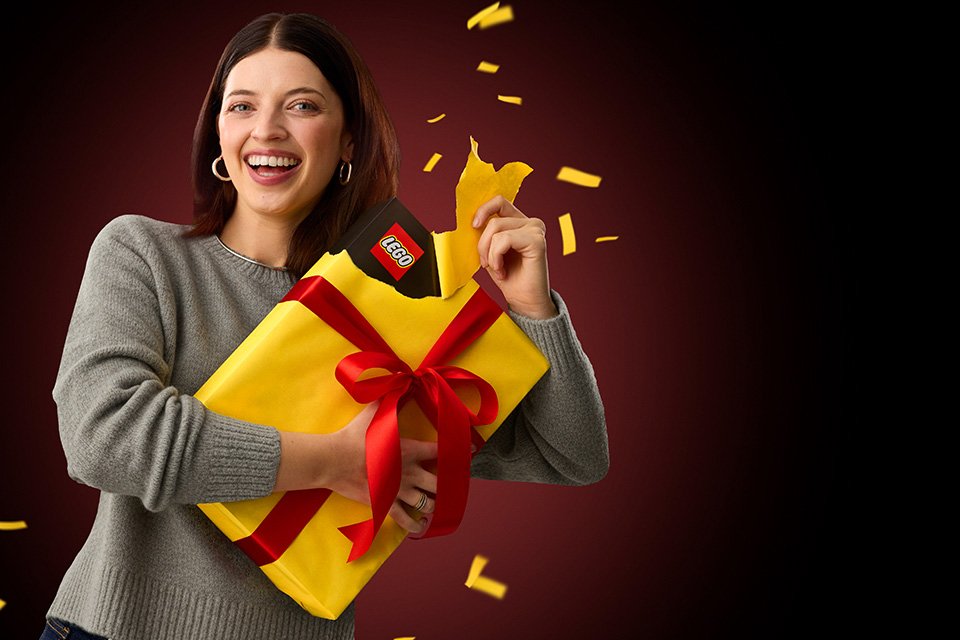 Woman opening a LEGO® gift. 