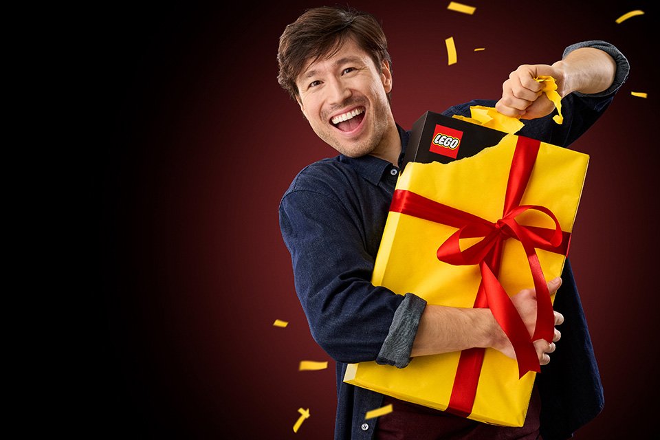 Man opening a LEGO® gift. 