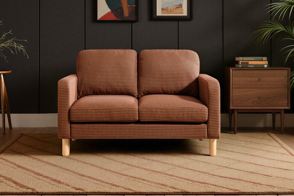 Argos Home Luna Dogtooth fabric 2-seater sofa in rust colour.