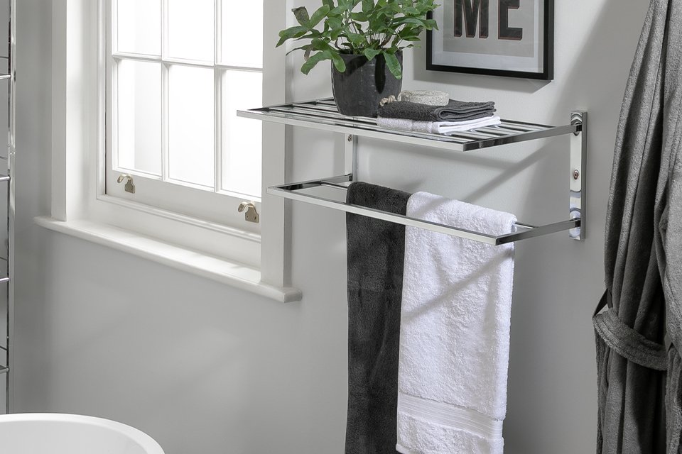 A steel towel holder wallmounted in a bathroom.