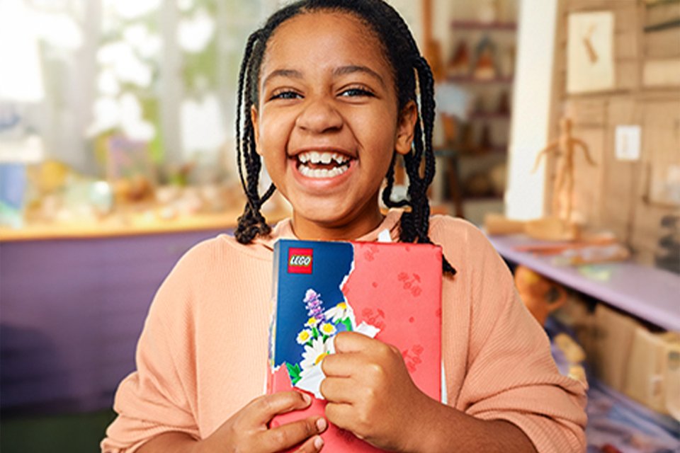 Girl opening a LEGO® Botanicals gift.