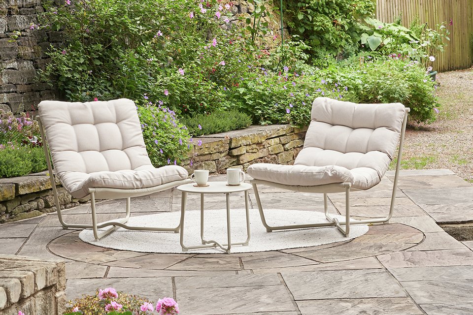 A Pacific Clermont set of 2 outdoor lounging chairs placed outdoors.