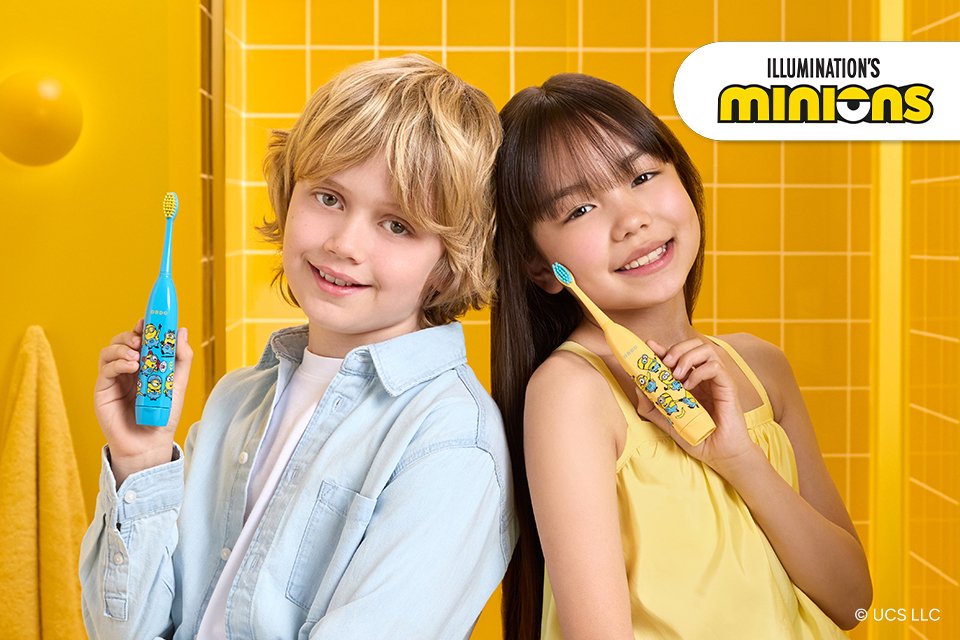 Boy and girl holding their Minions ORDO Sonic Kids Toothbrushes in blue and yellow colours. 