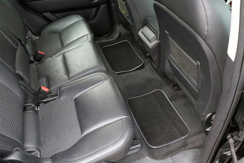 A black carpet mat in a car.