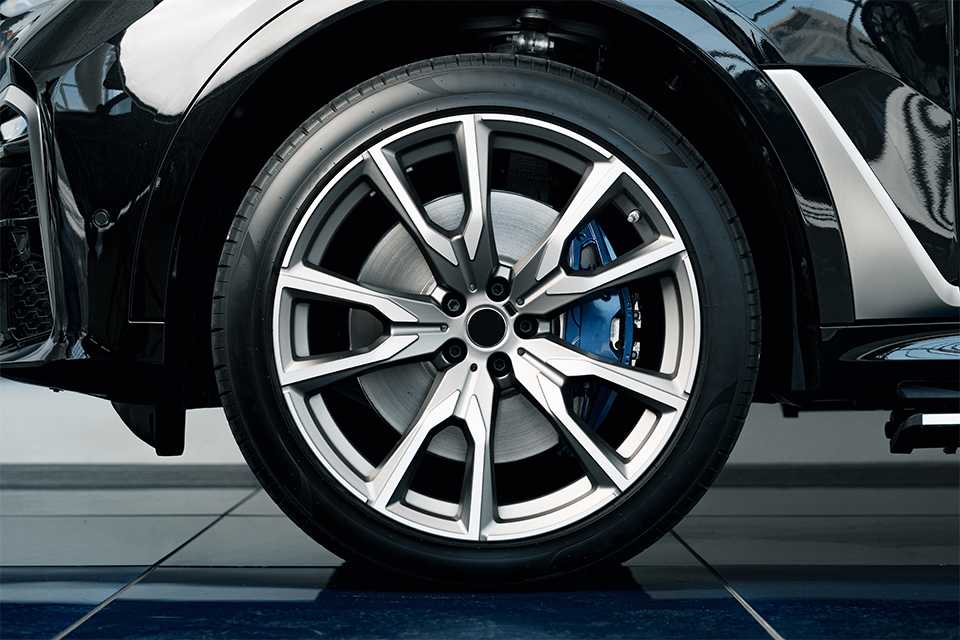 A close-up shot of aluminium rim of a luxury car wheel.