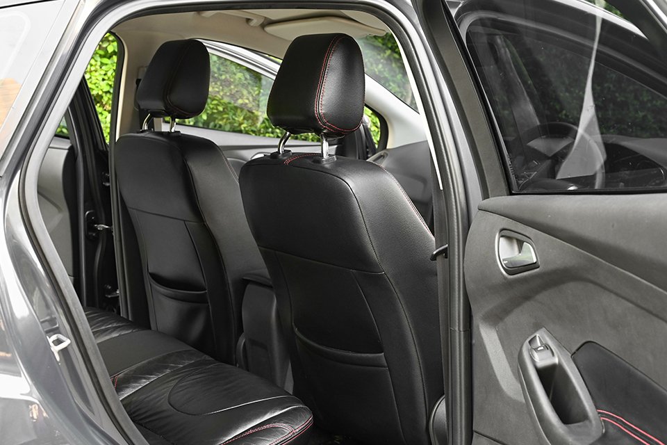 Black seat covers on all the seats of a car.