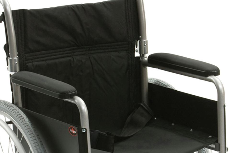 Close up of wheelchair with padded armrests.