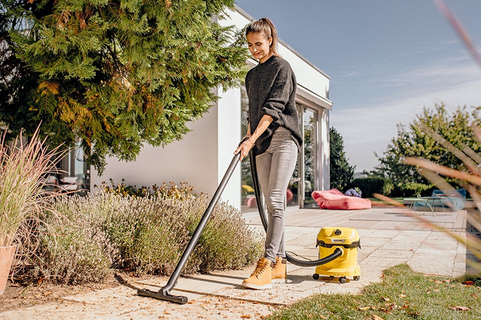 A woman using Kärcher wet & dry vacuum.