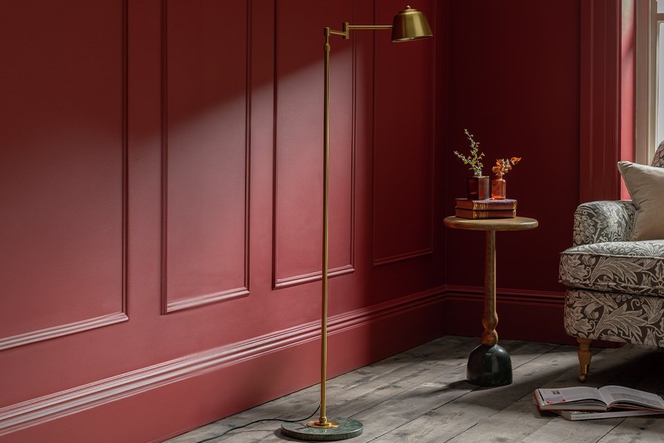 Brown velvet chair at wooden dining table.