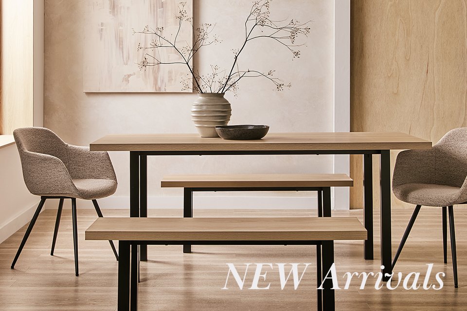Dining room table wooden with matching benches and two boucle chairs either end.