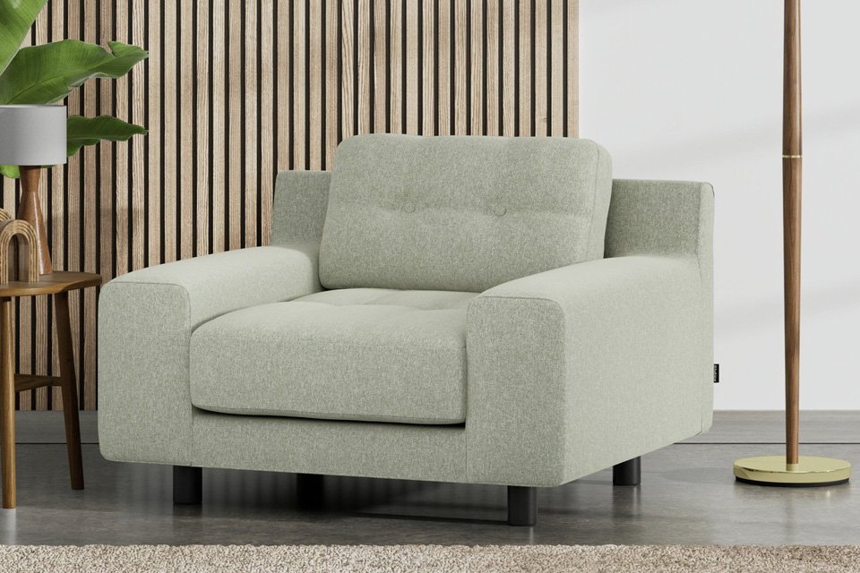A Habitat Hendricks Fabric arm chair in sage green with black legs.