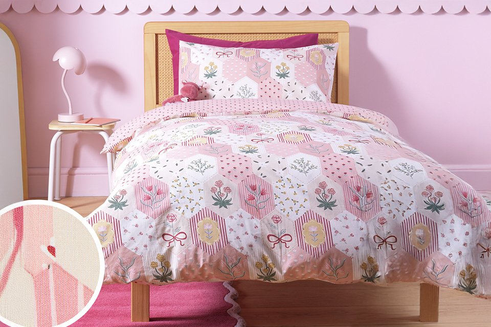 An Argos Home kids' floral patchwork pink toddler bedding set.