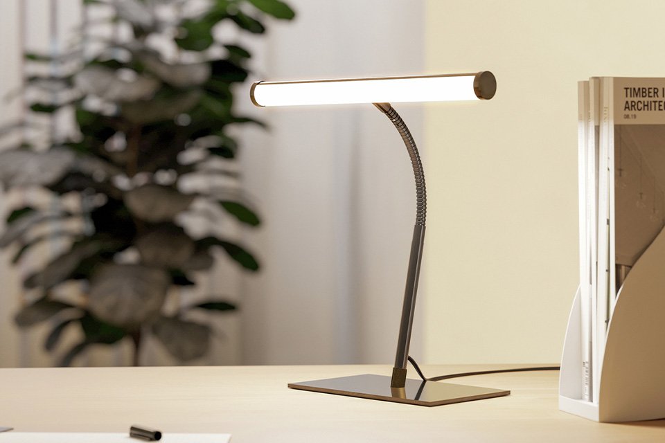 An EGLO Riccione black LED desk lamp on a table.