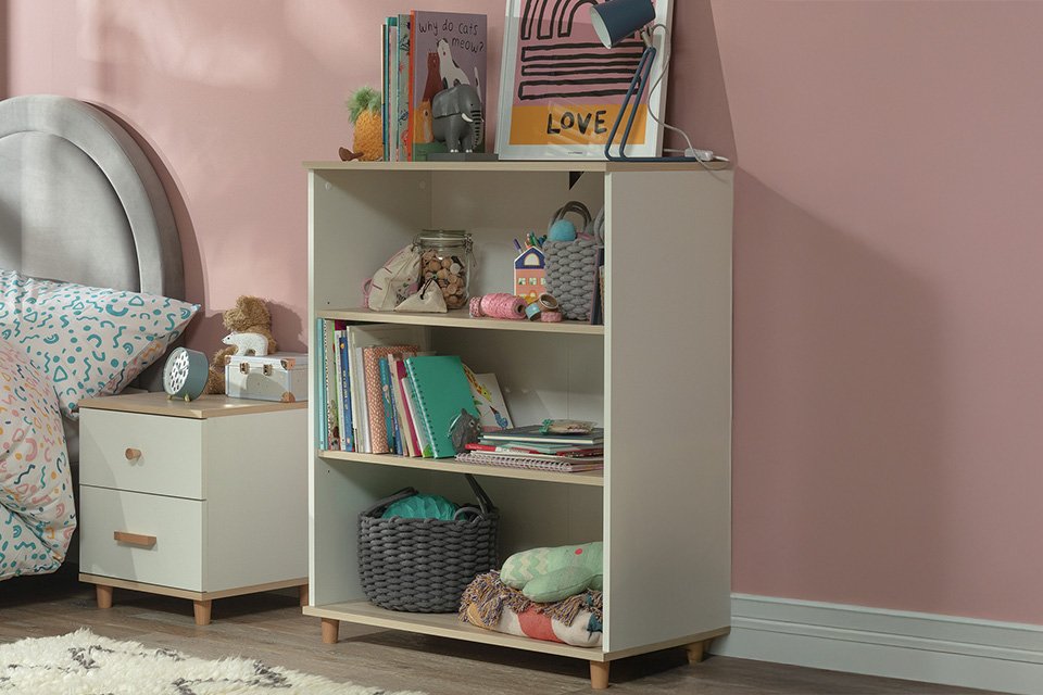 A Habitat Melby deep bookcase being used as storage for a kids' room.