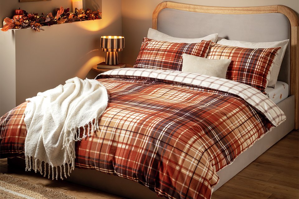 Home Autumnal Brushed Check bedding on a natural finish bed.