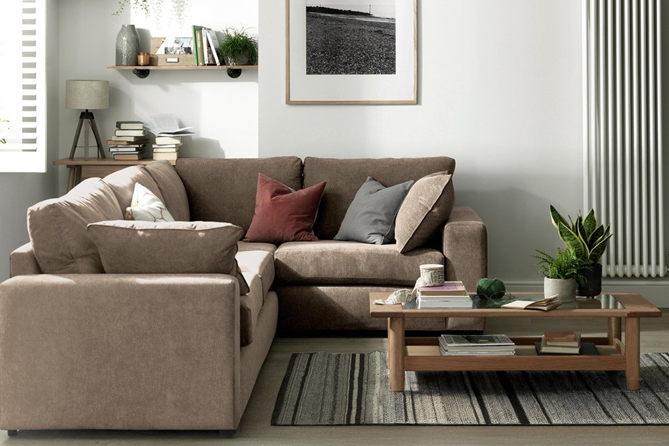 A wooden coffee table and a Habitat Elmdon fabric right hand corner sofa in a living room.