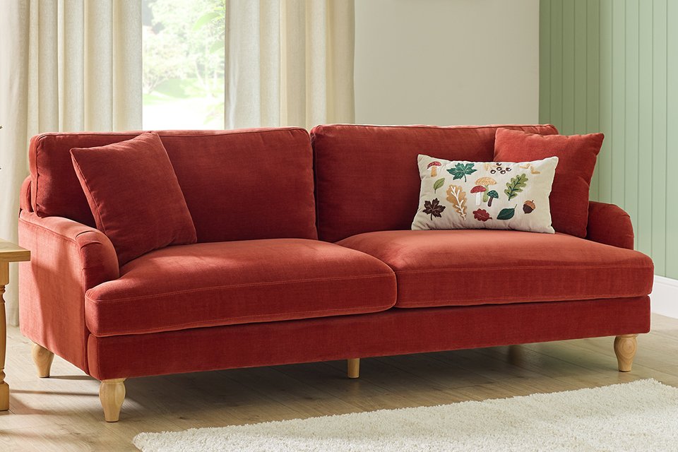 A velvet sofa in a living room.