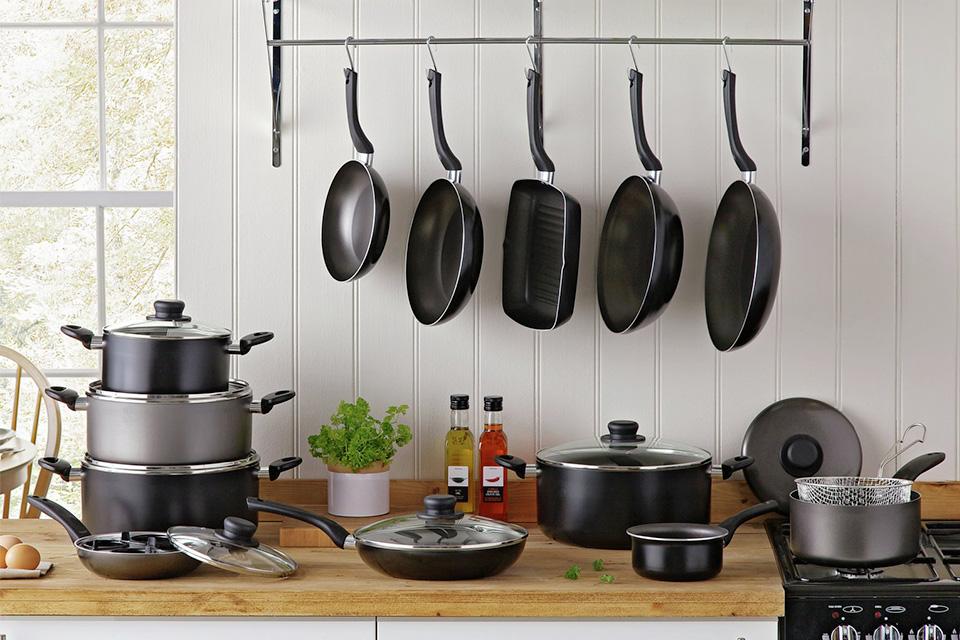 A range of frying pans, skillets, saucepans and casserole dishes in a kitchen.