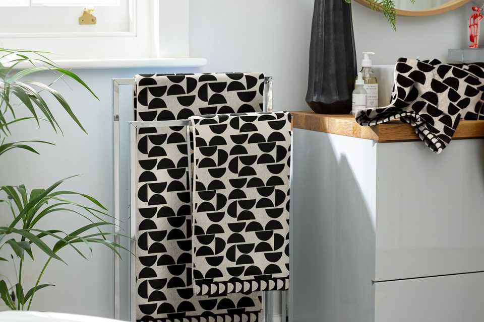 Black and white geometric towels in bathroom.